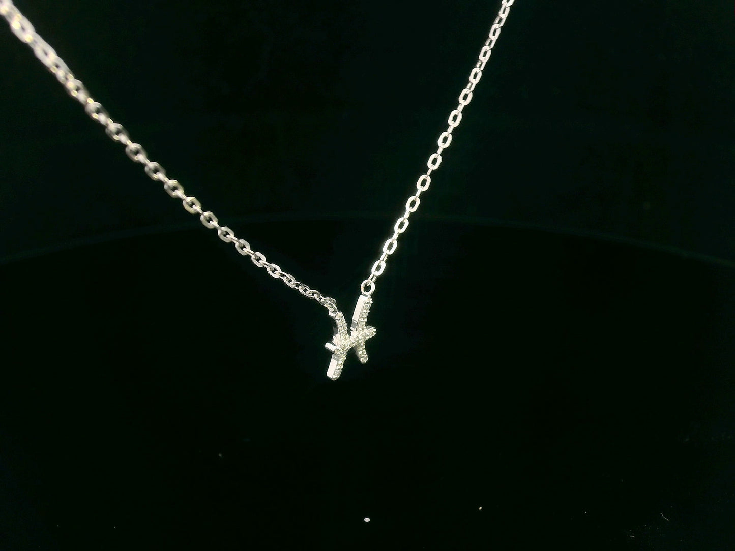 Pisces zodiac necklace in 18K gold with 0.06 carat diamond accents on fine chain