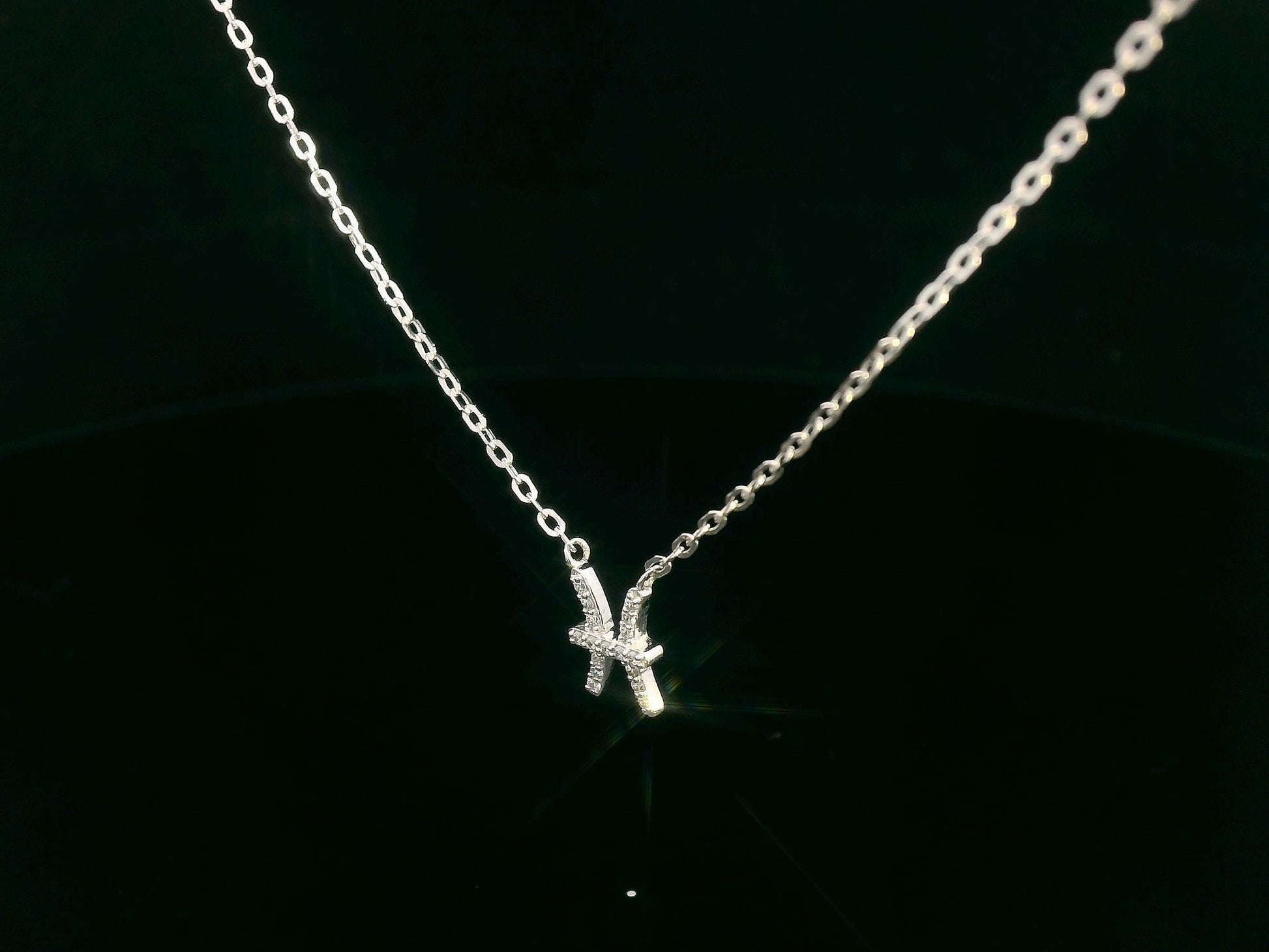 Pisces zodiac necklace in 18K gold with 0.06 carat diamond accents on fine chain