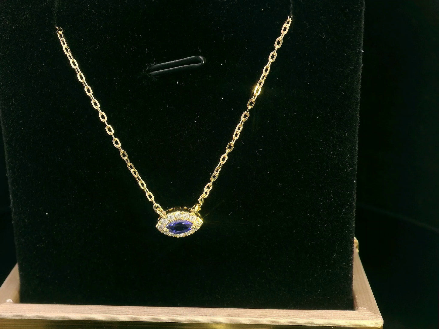 Minimalist marquise-cut Tanzanite pendant necklace in 18K yellow gold with diamond halo