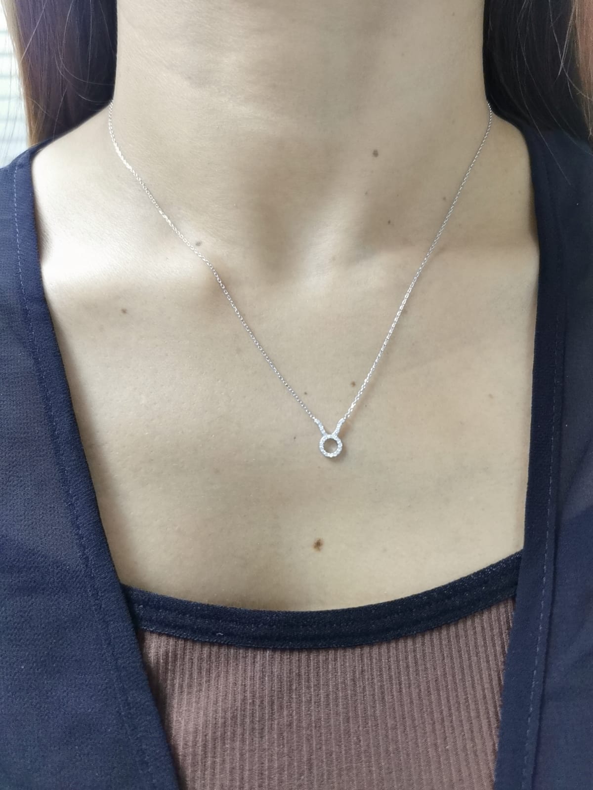 Taurus zodiac sign necklace in 18K white gold with 0.09 carat diamond accents.