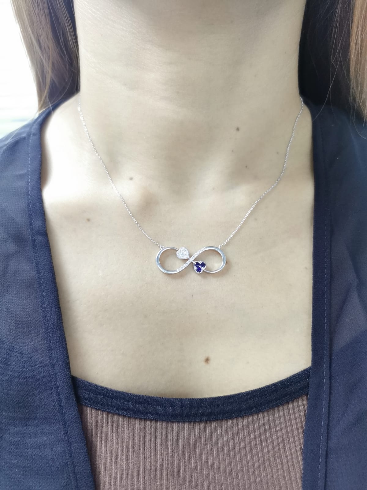 18K gold infinity necklace with heart-shaped diamond and sapphire accents, total 0.21 CT each