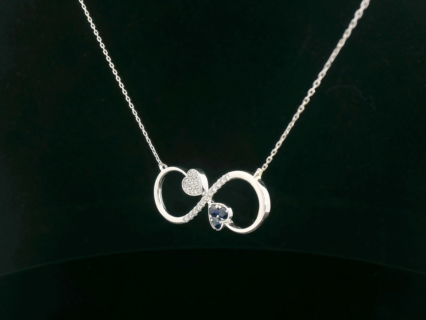 18K gold infinity necklace with heart-shaped diamond and sapphire accents, total 0.21 CT each