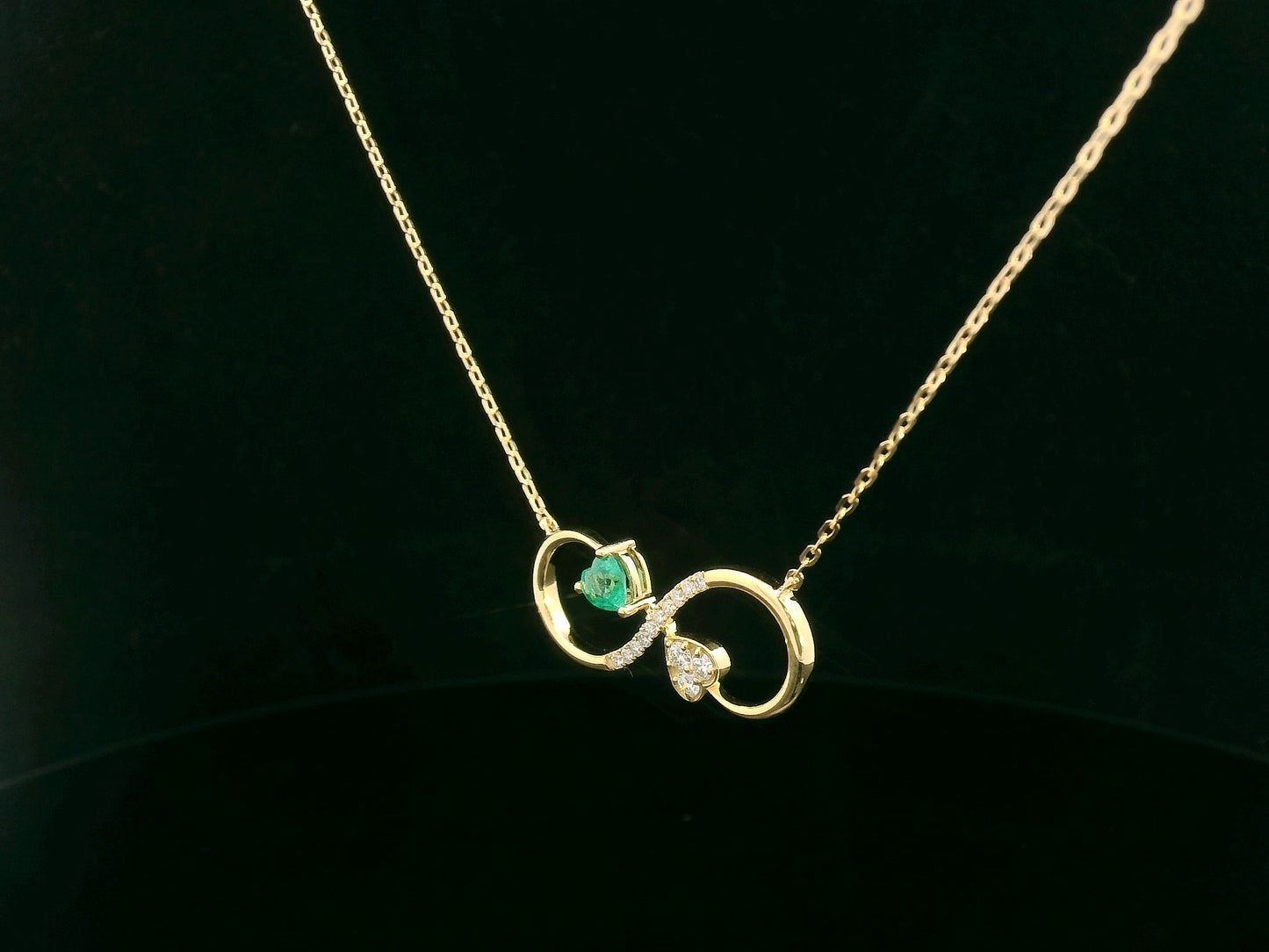 Infinity loop necklace with asymmetrical heart design