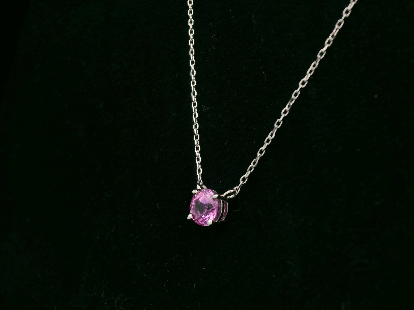 18K white gold pink sapphire solitaire necklace featuring a 0.61 carat round pink sapphire pendant by Emirates Diamonds