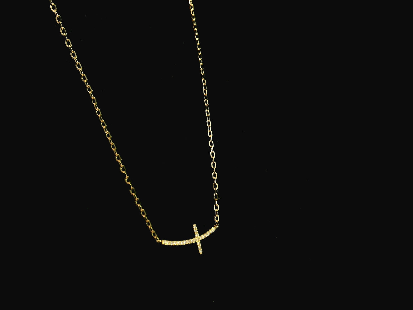Diamond cross necklace in 18K yellow gold featuring 0.06 carats of diamonds by Emirates Diamonds.