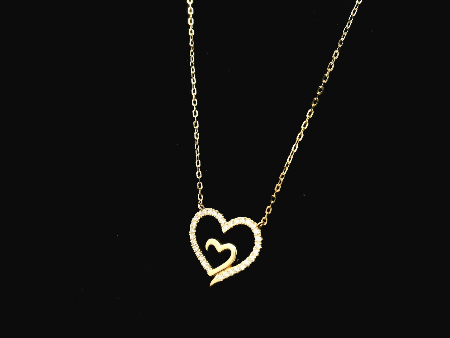 18K yellow gold open heart diamond necklace with pavé diamonds and modern romantic design.