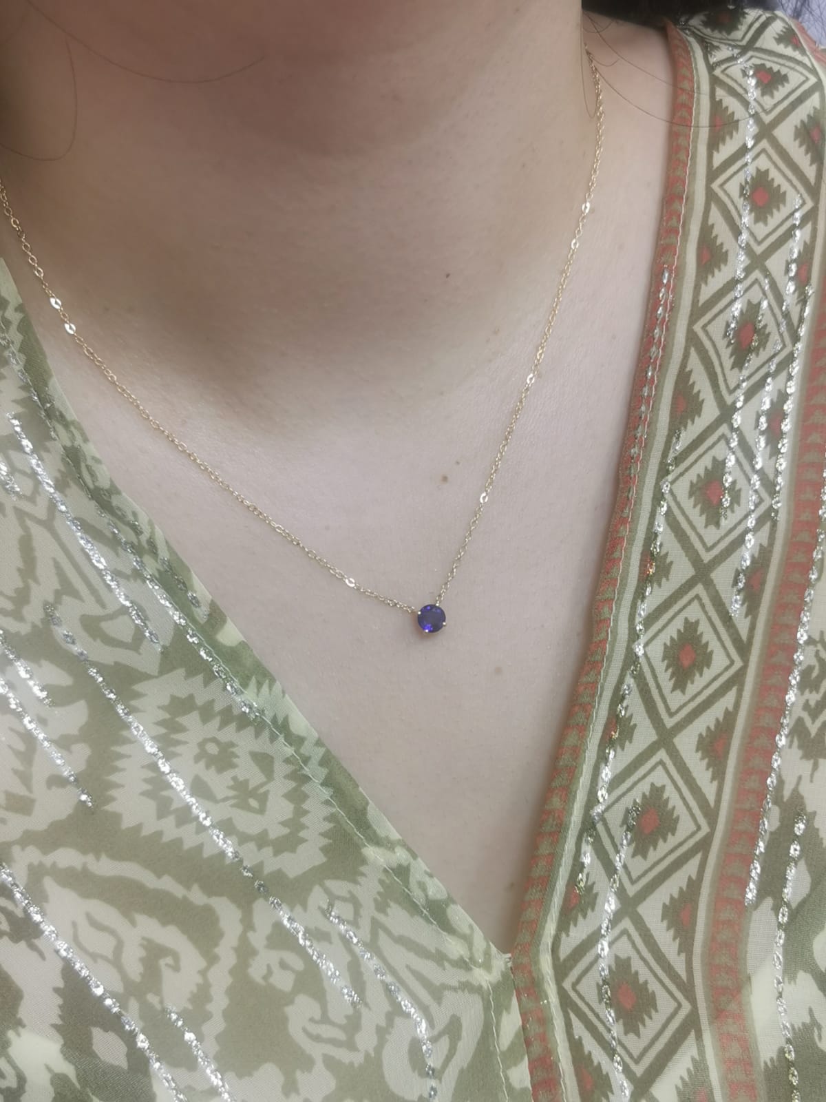 18K gold necklace featuring a round 0.89 carat blue sapphire pendant on a fine gold cable chain. Minimalist design with timeless elegance.