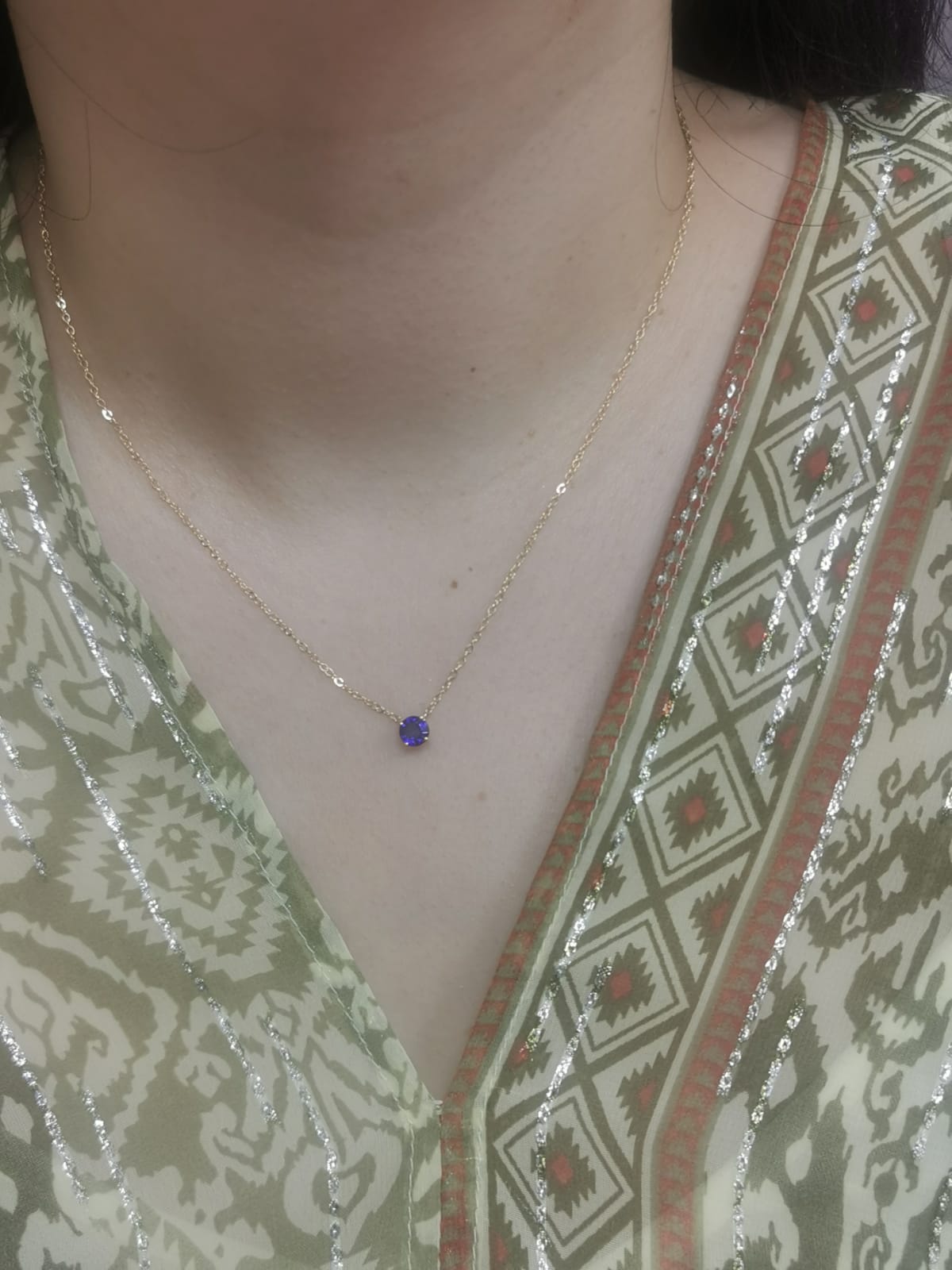 18K gold necklace featuring a round 0.89 carat blue sapphire pendant on a fine gold cable chain. Minimalist design with timeless elegance.