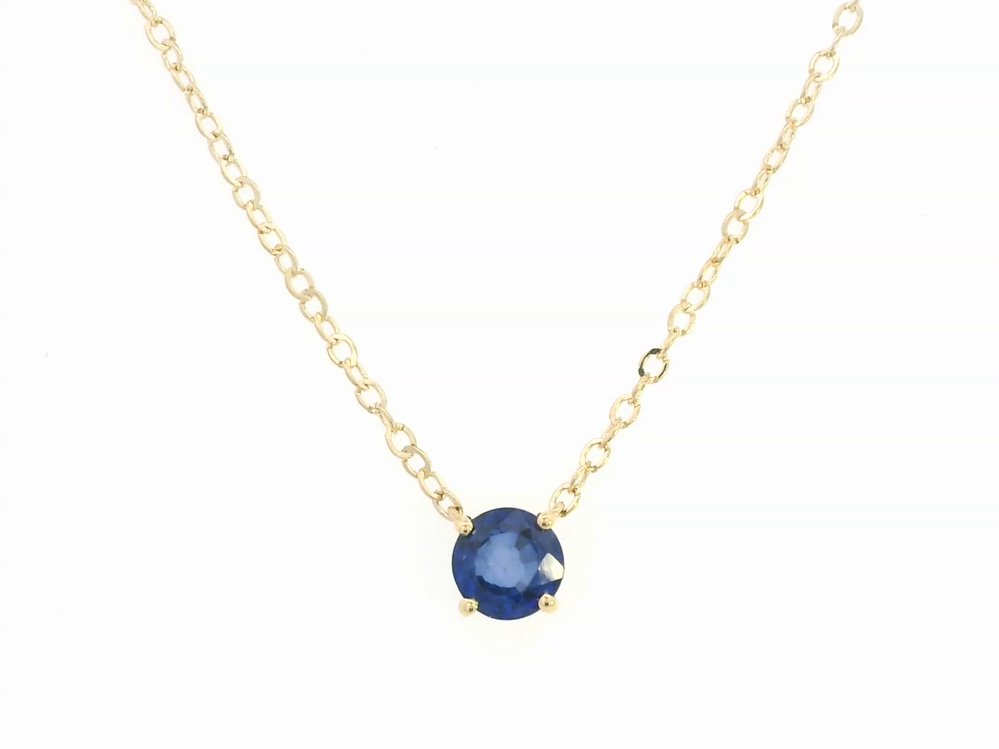 18K gold necklace featuring a round 0.89 carat blue sapphire pendant on a fine gold cable chain. Minimalist design with timeless elegance.
