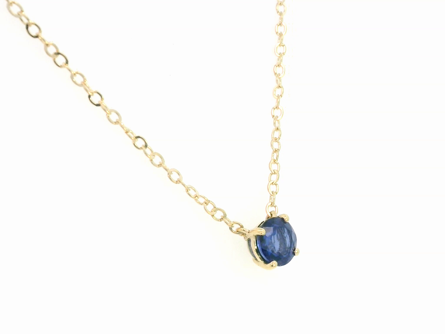18K gold necklace featuring a round 0.89 carat blue sapphire pendant on a fine gold cable chain. Minimalist design with timeless elegance.