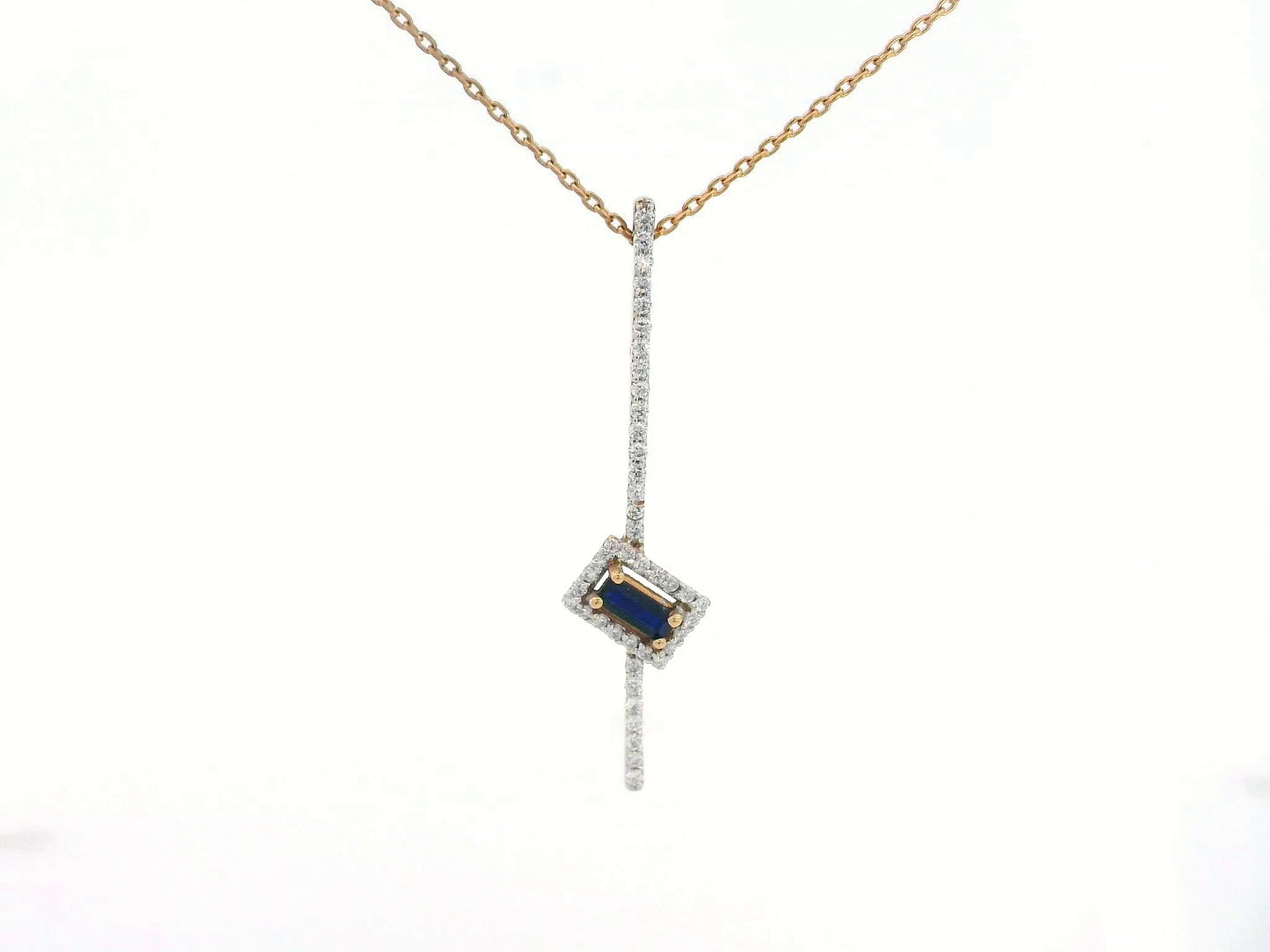 18K gold pendant with vertical diamond bar and tilted halo-set 0.19 carat blue sapphire