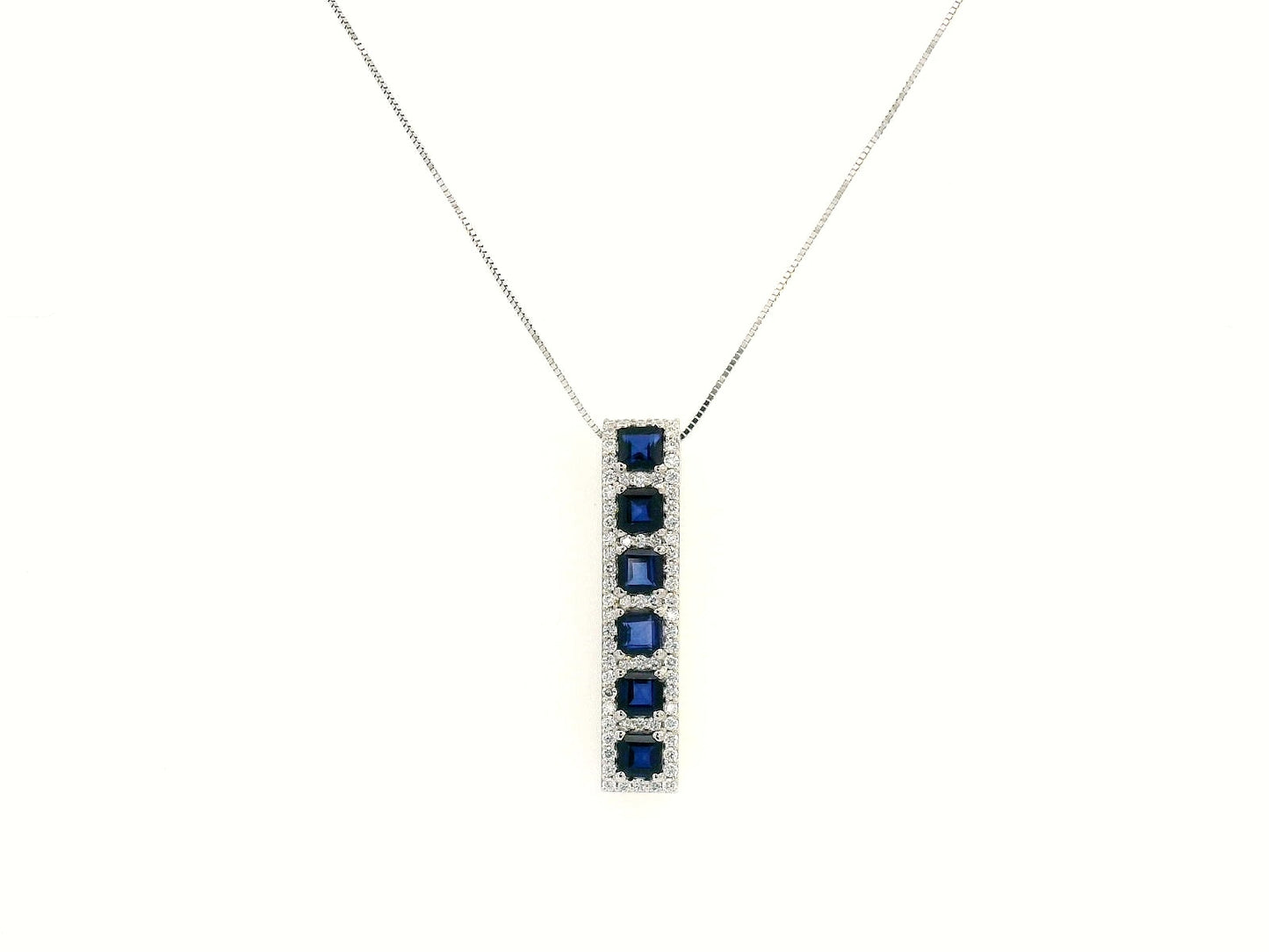 18K Yellow Gold Sapphire and Diamond Pendant featuring 1.45 carats of square-cut sapphires and a 0.34-carat diamond halo in a sleek vertical design.