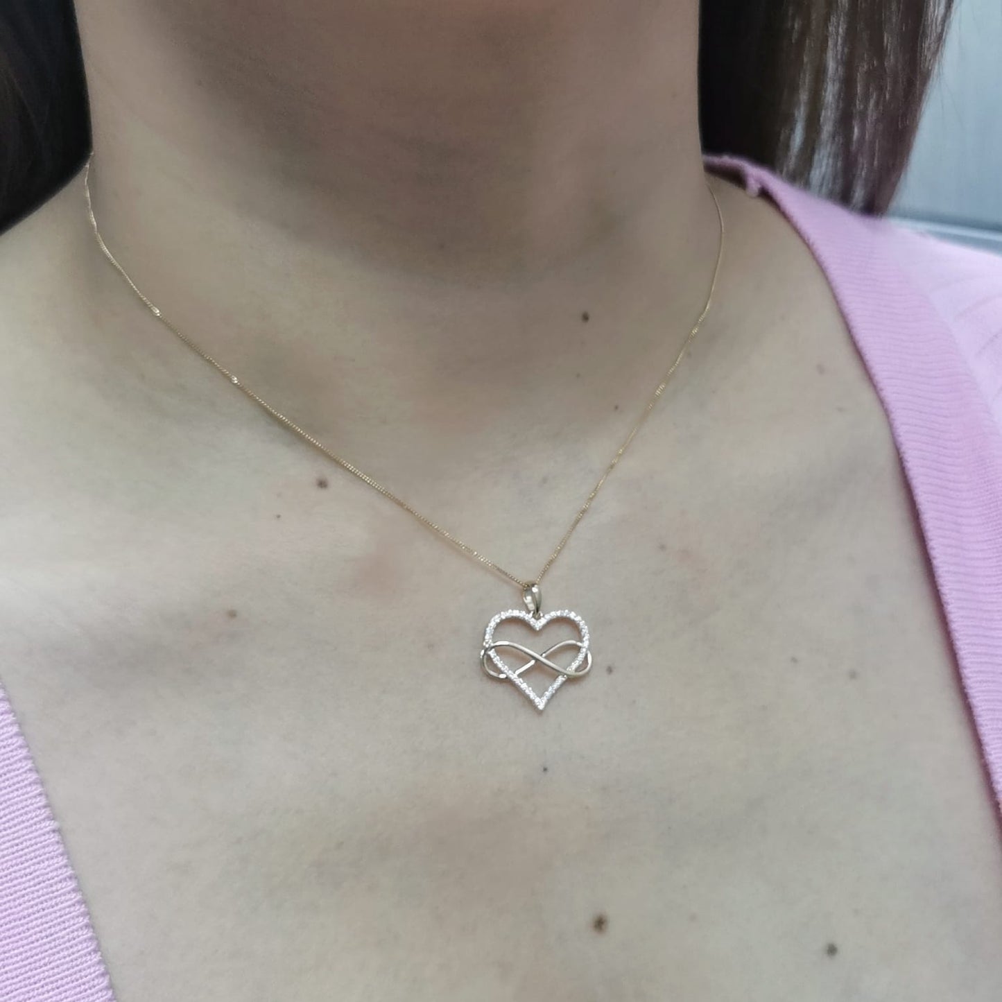 18K gold heart and infinity pendant with 0.22ct pave-set diamonds, symbolizing eternal love. Chain not included.