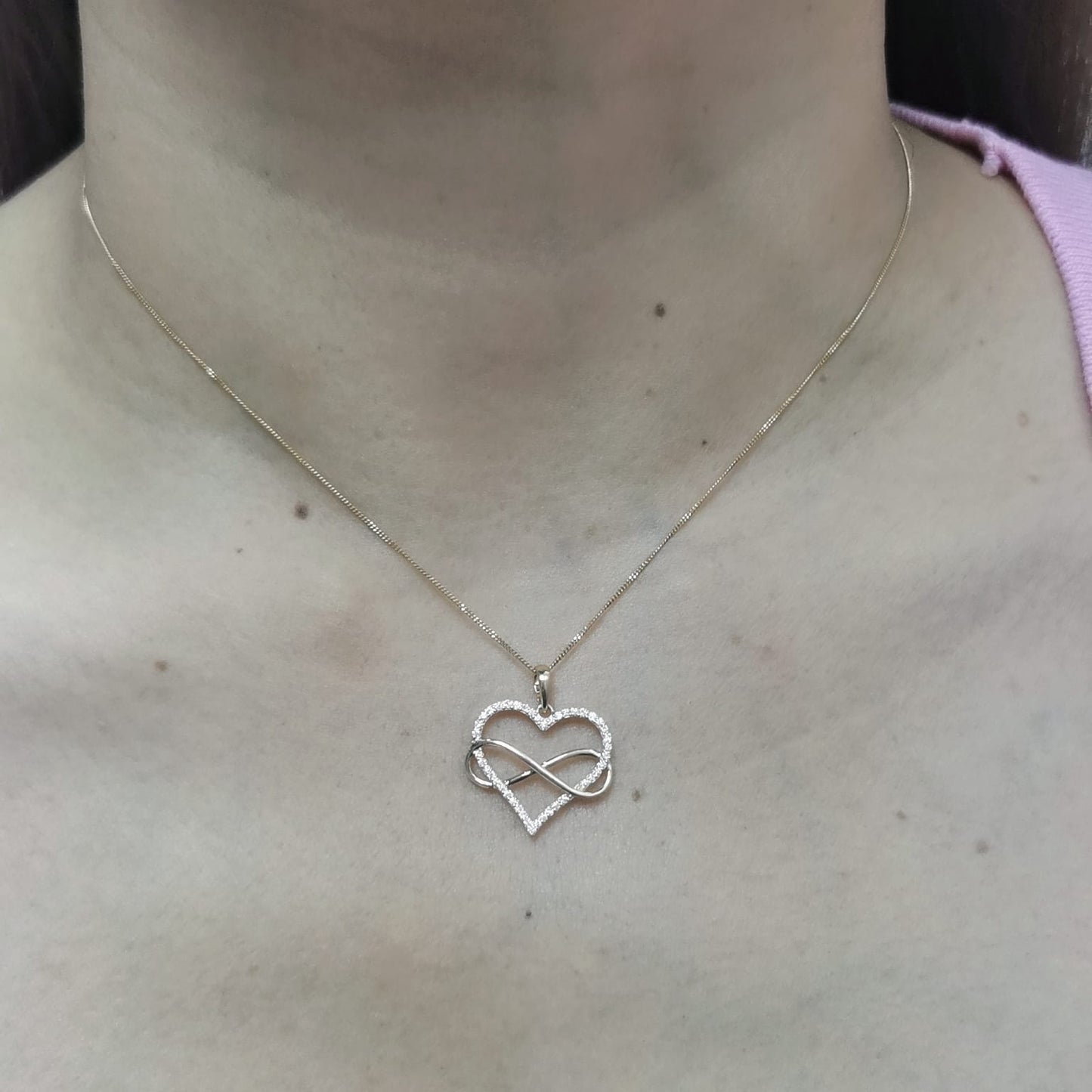 18K gold heart and infinity pendant with 0.22ct pave-set diamonds, symbolizing eternal love. Chain not included.