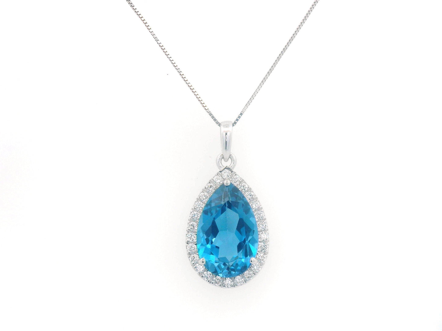 18K white gold pendant with a 5.87ct pear-shaped London Blue Topaz, surrounded by a 0.33ct diamond halo. Chain not included.