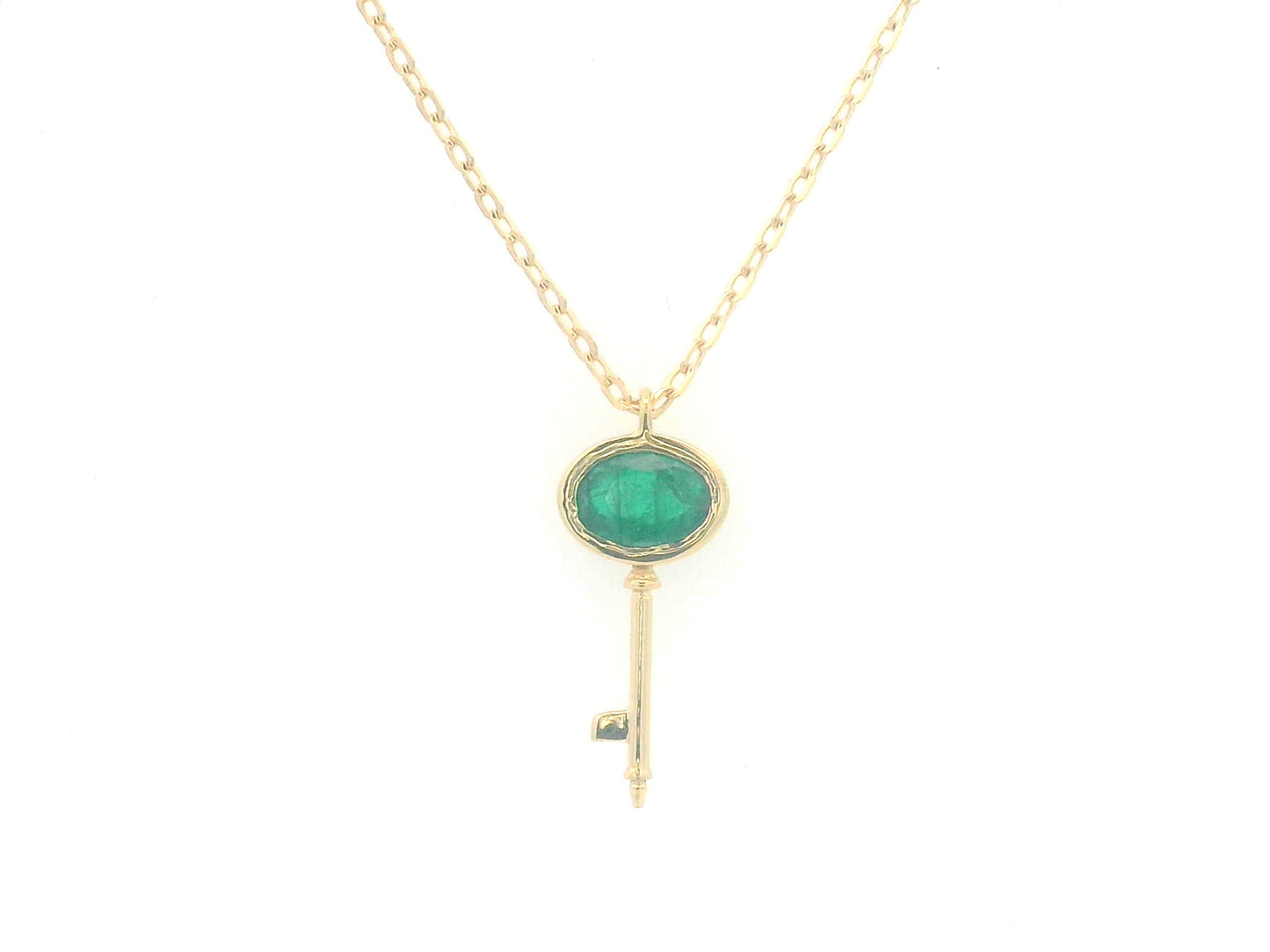 18K gold key pendant necklace with a 0.39ct natural emerald, featuring a sleek bezel setting and a delicate gold chain.