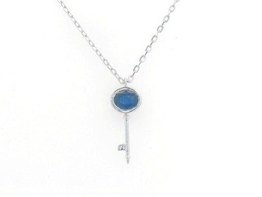 18K gold key pendant necklace with a 0.40ct natural sapphire in a bezel setting, complete with a delicate gold chain.