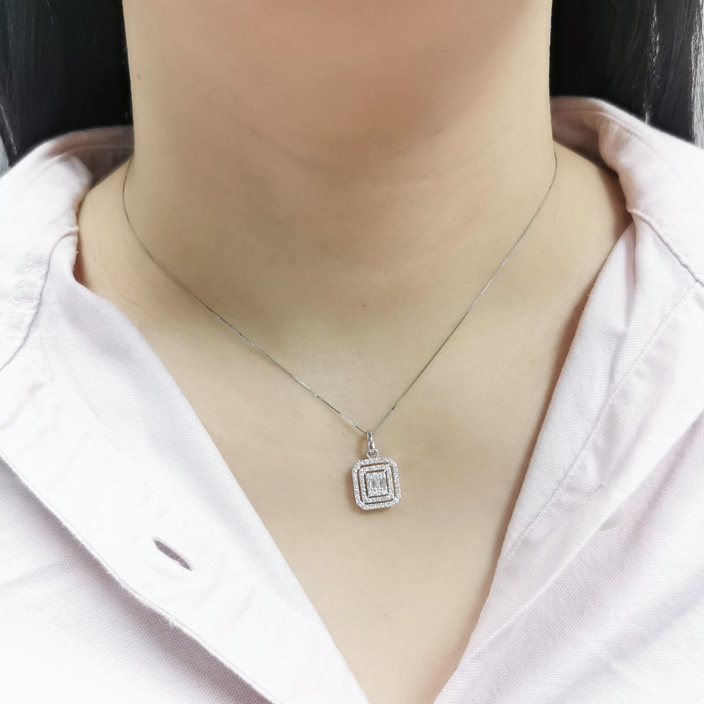 18K gold diamond pendant featuring baguette and round-cut diamonds, totaling 0.50ct, with a radiant double halo design.