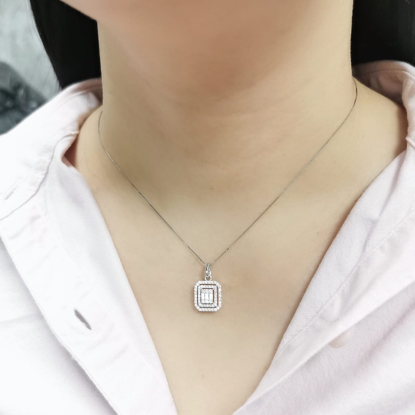 18K gold diamond pendant featuring baguette and round-cut diamonds, totaling 0.50ct, with a radiant double halo design.