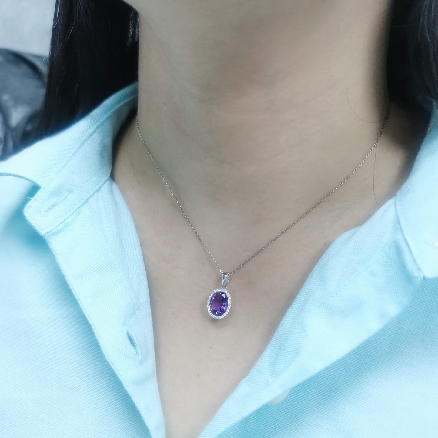 18K yellow gold pendant featuring a 2.50-carat oval Amethyst with a delicate 0.11-carat diamond halo. Elegant and timeless.