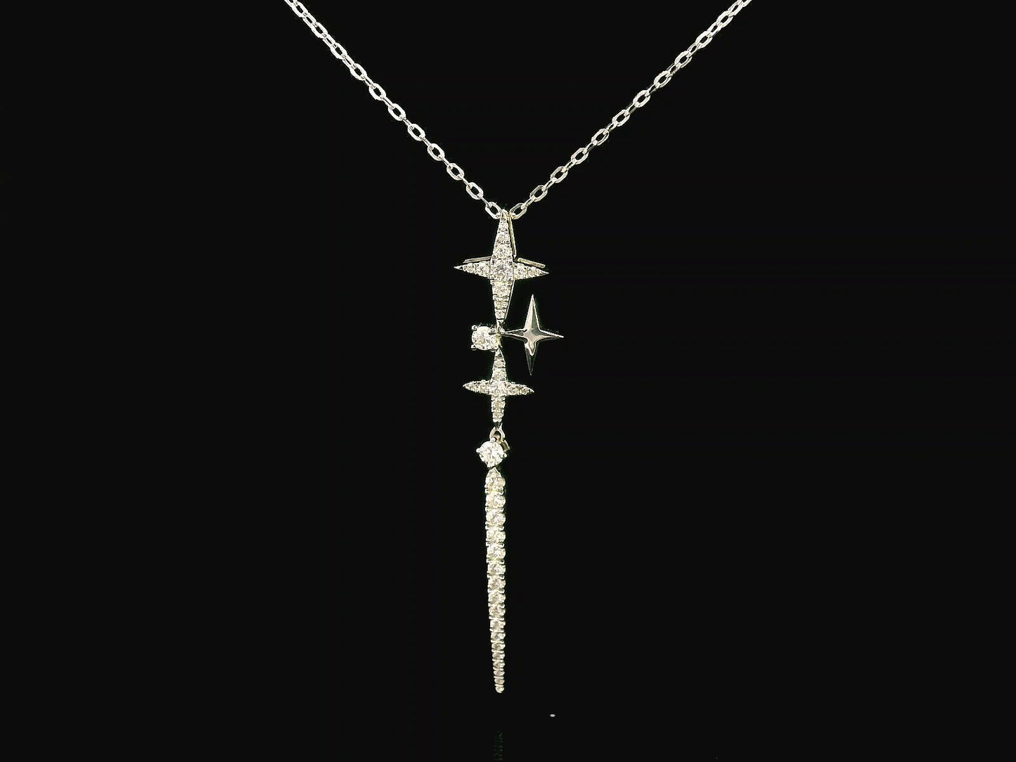 18K gold celestial-inspired pendant with cascading star motifs, 0.49 carats of diamonds, and an elongated diamond-studded drop. Elegant and perfect for layering.