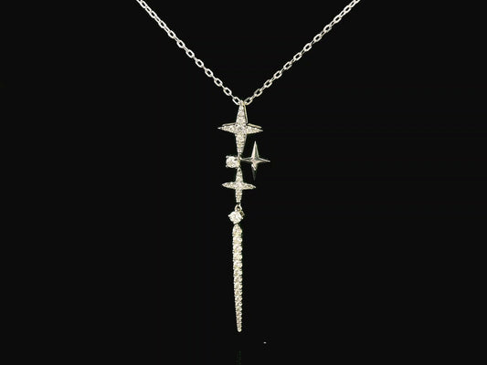 18K gold celestial-inspired pendant with cascading star motifs, 0.49 carats of diamonds, and an elongated diamond-studded drop. Elegant and perfect for layering.