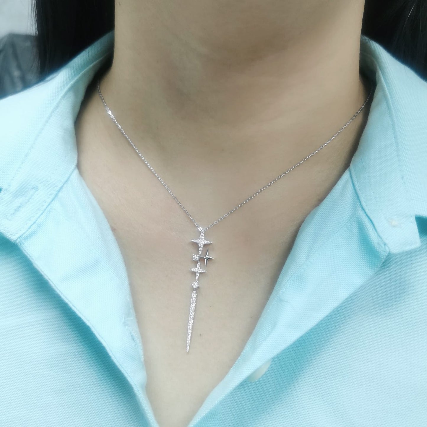 18K gold celestial-inspired pendant with cascading star motifs, 0.49 carats of diamonds, and an elongated diamond-studded drop. Elegant and perfect for layering.