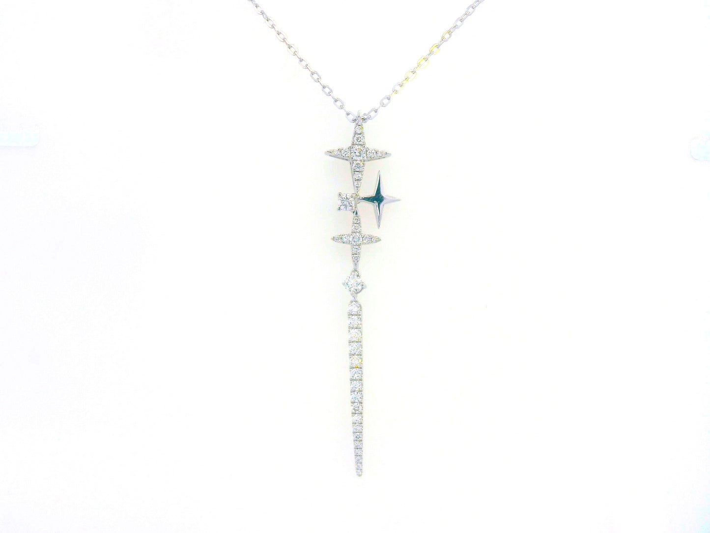 18K gold celestial-inspired pendant with cascading star motifs, 0.49 carats of diamonds, and an elongated diamond-studded drop. Elegant and perfect for layering.