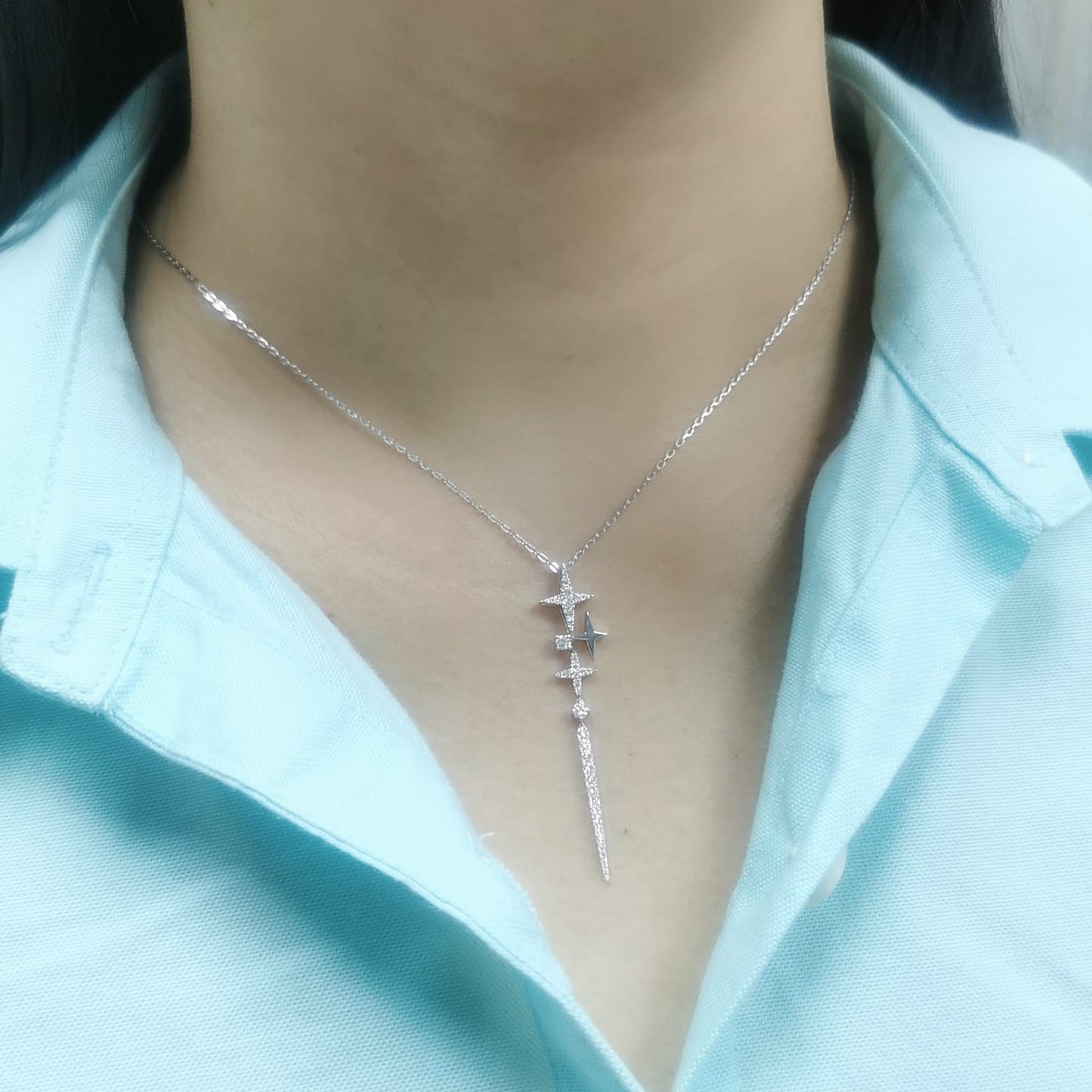 18K gold celestial-inspired pendant with cascading star motifs, 0.49 carats of diamonds, and an elongated diamond-studded drop. Elegant and perfect for layering.