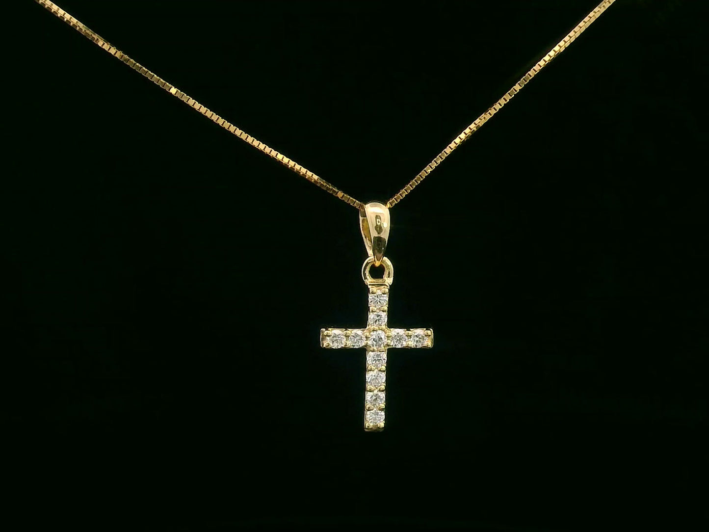 Petite diamond cross pendant in 18K gold with 11 round-cut diamonds totaling 0.13 carat