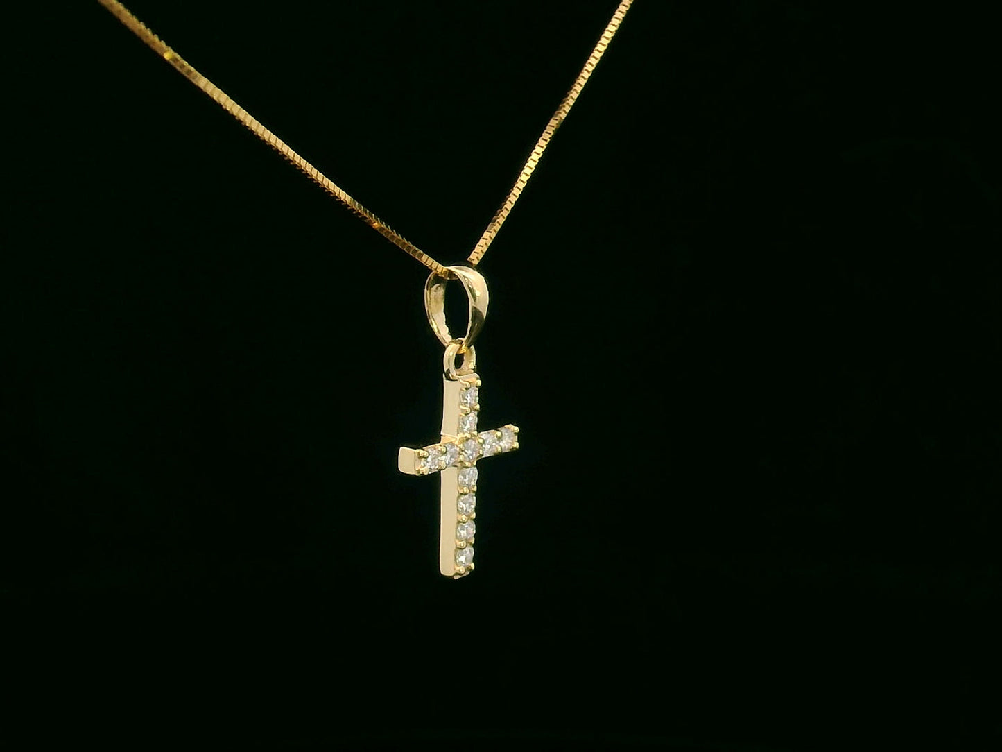 Petite diamond cross pendant in 18K gold with 11 round-cut diamonds totaling 0.13 carat