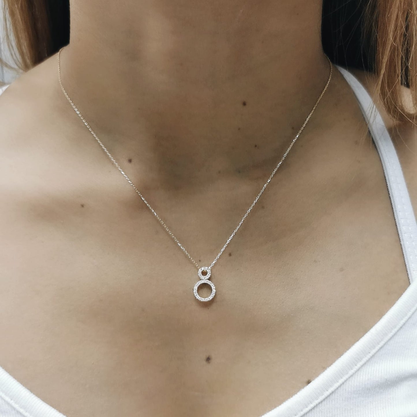 18K gold pendant necklace with double open circle design set with 0.18 carat pavé diamonds