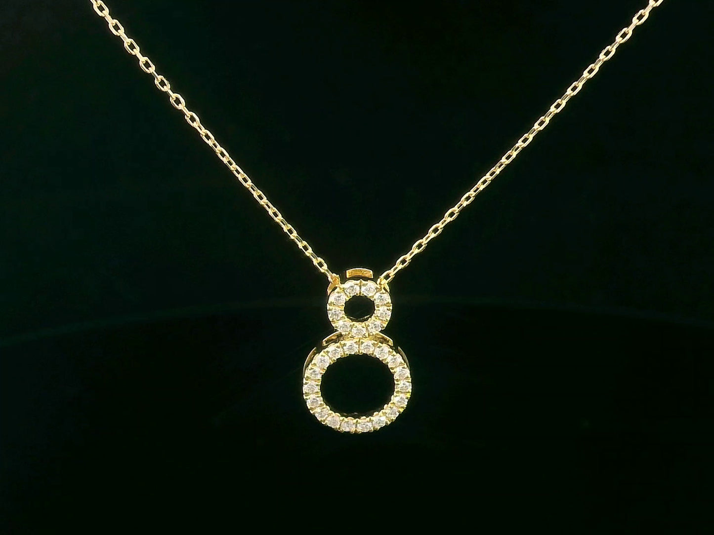 18K gold pendant necklace with double open circle design set with 0.18 carat pavé diamonds