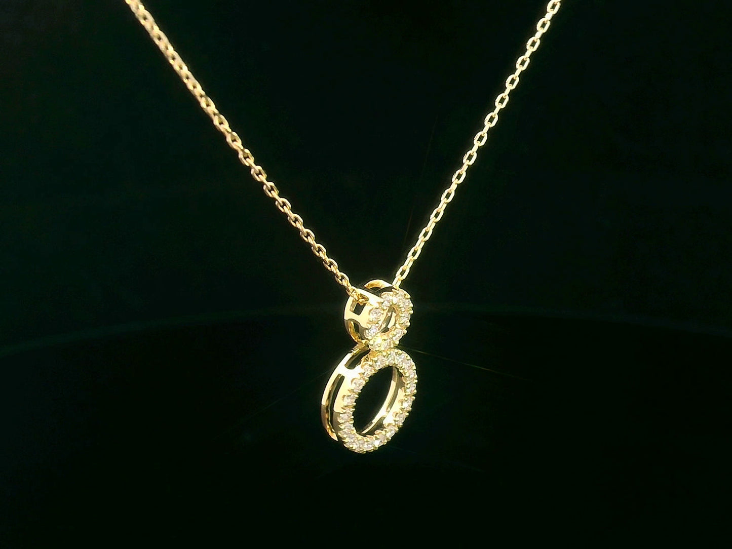 18K gold pendant necklace with double open circle design set with 0.18 carat pavé diamonds