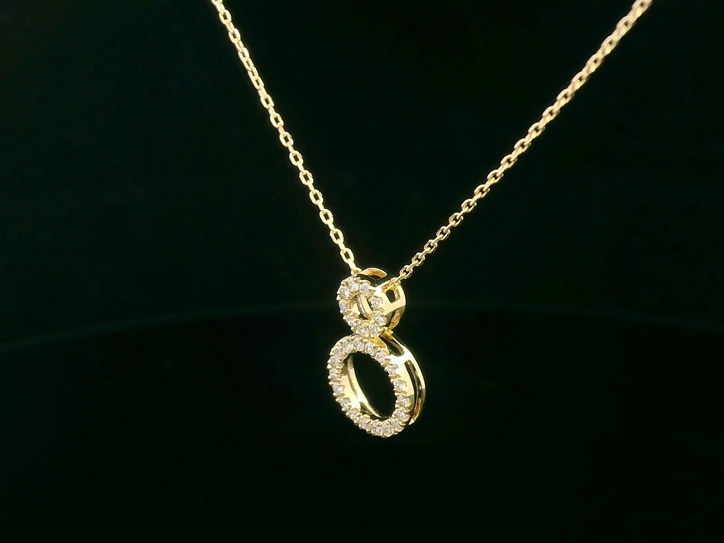 18K gold pendant necklace with double open circle design set with 0.18 carat pavé diamonds