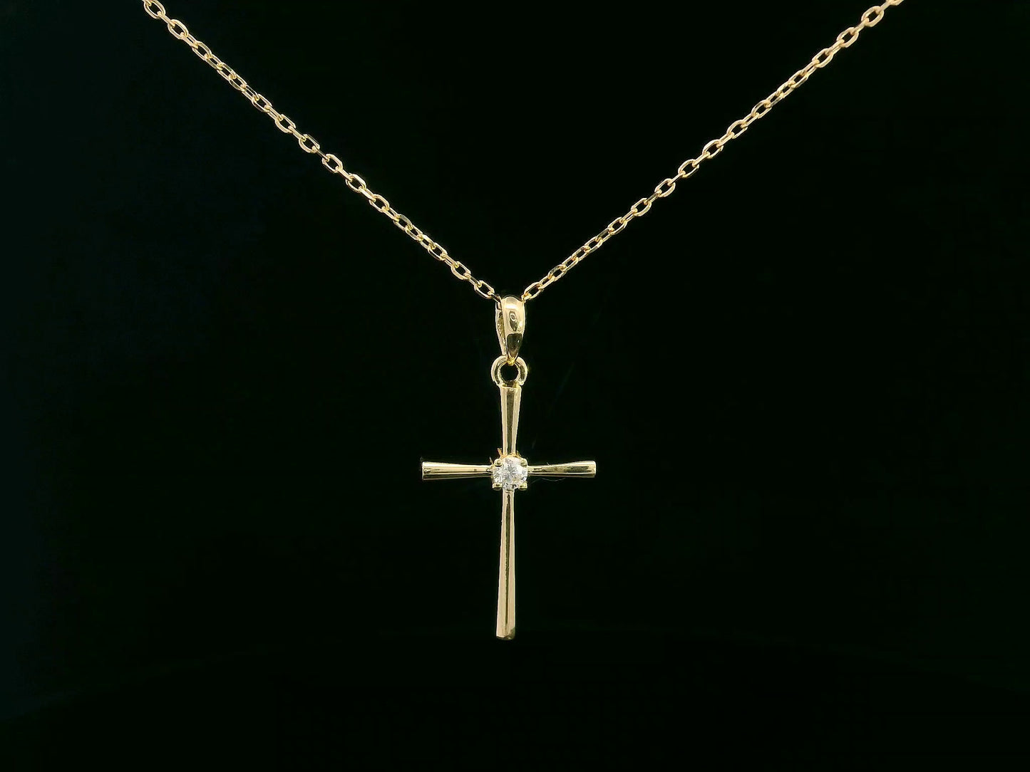 18K yellow gold cross pendant with 0.05 carat center diamond, minimalist design, chain not included
