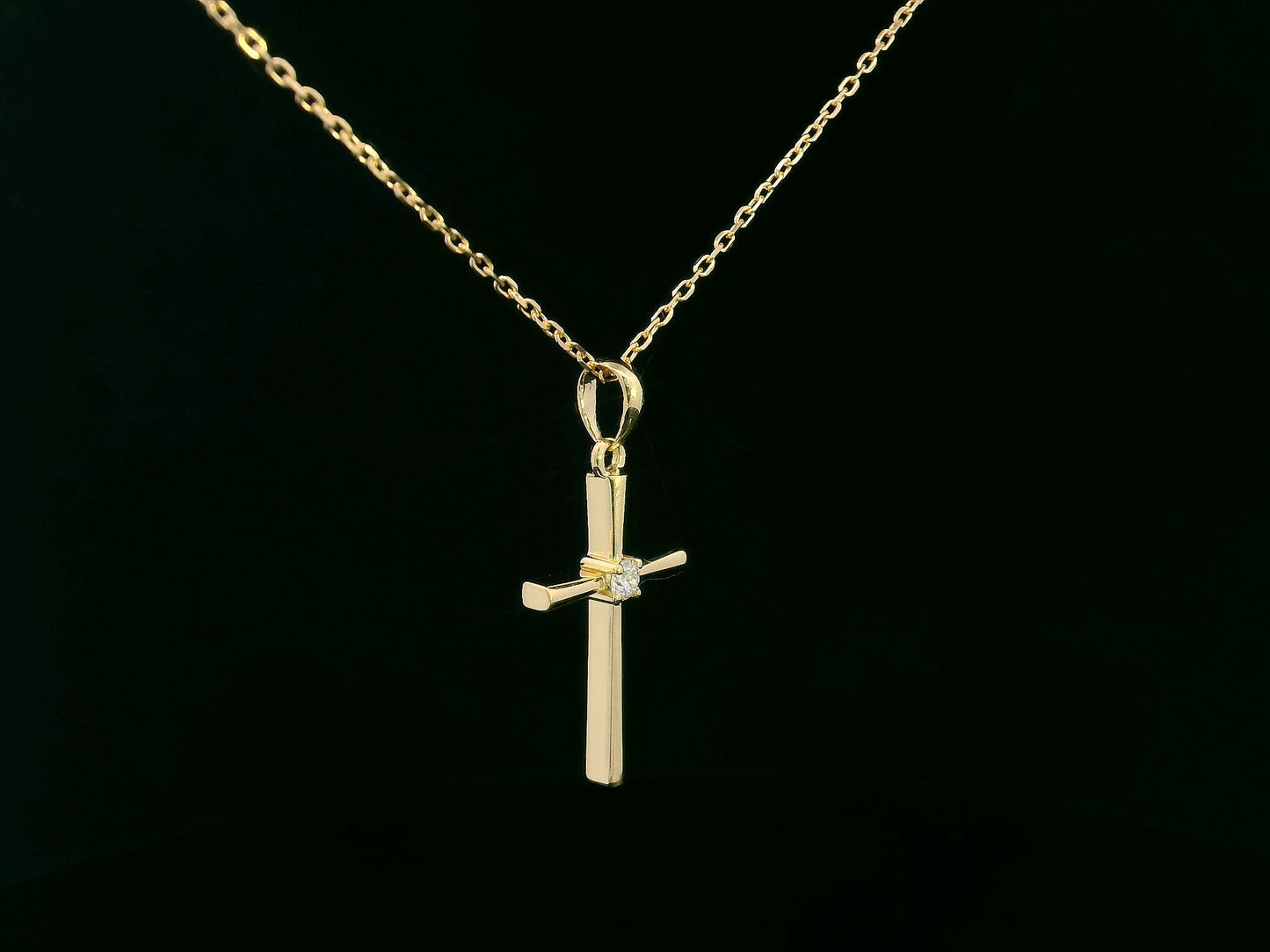 18K yellow gold cross pendant with 0.05 carat center diamond, minimalist design, chain not included