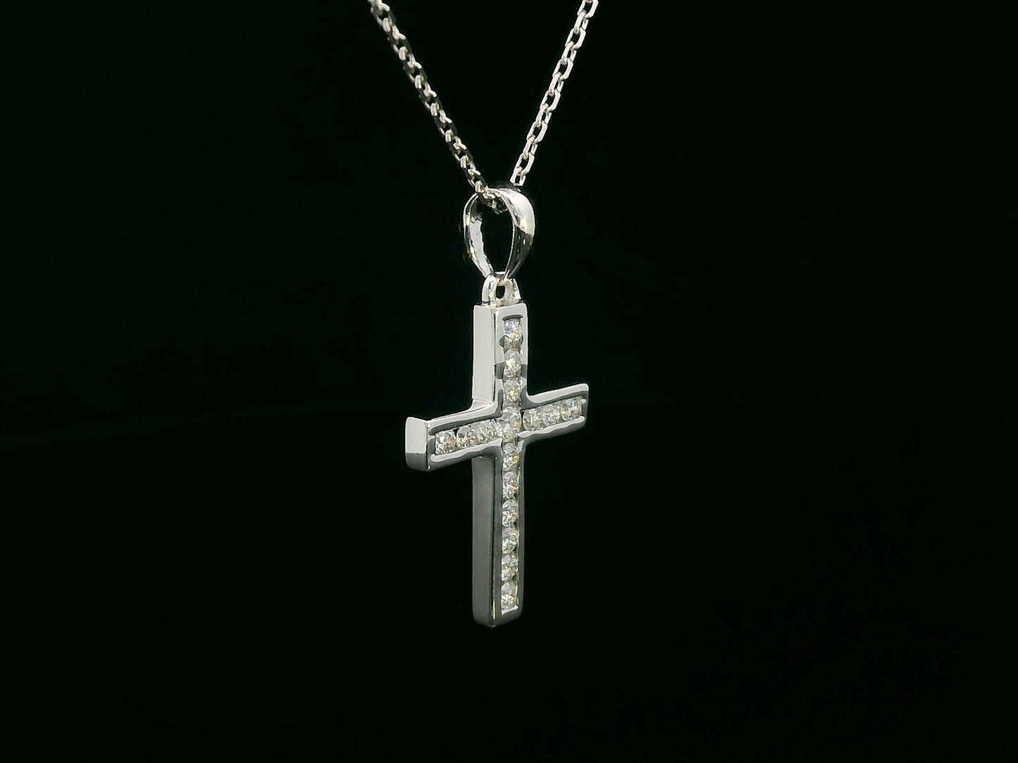 18K gold cross pendant with 0.20 carat round diamonds, religious charm on black background