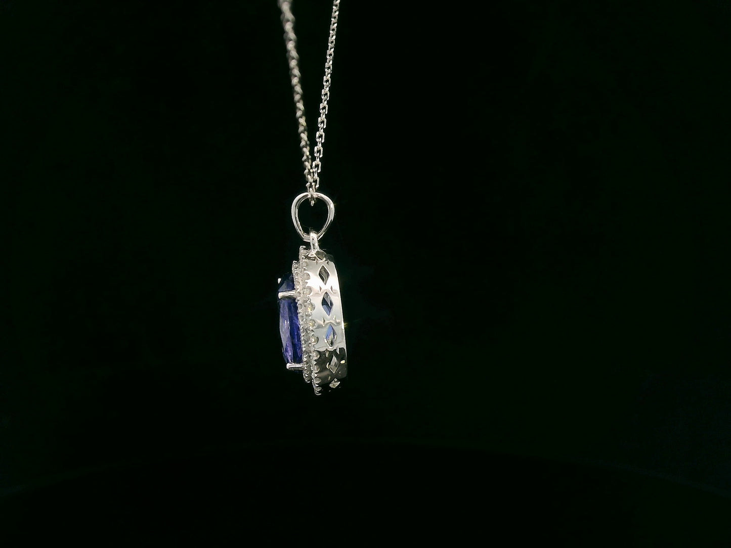 Tanzanite and diamond halo pendant in white gold