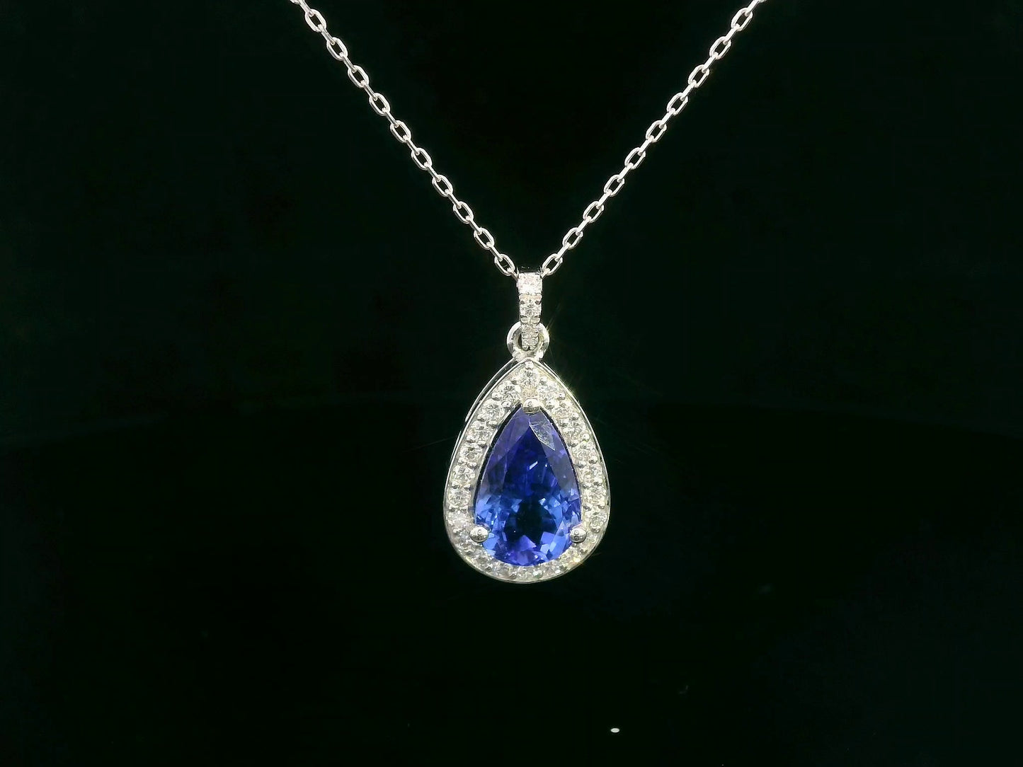 Pear-shaped Tanzanite pendant in 18K white gold with diamond halo and diamond-studded bail – 2.81ct total