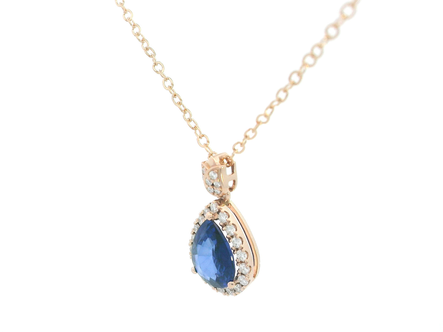 Elegant pear-cut sapphire pendant with floral-inspired diamond bail