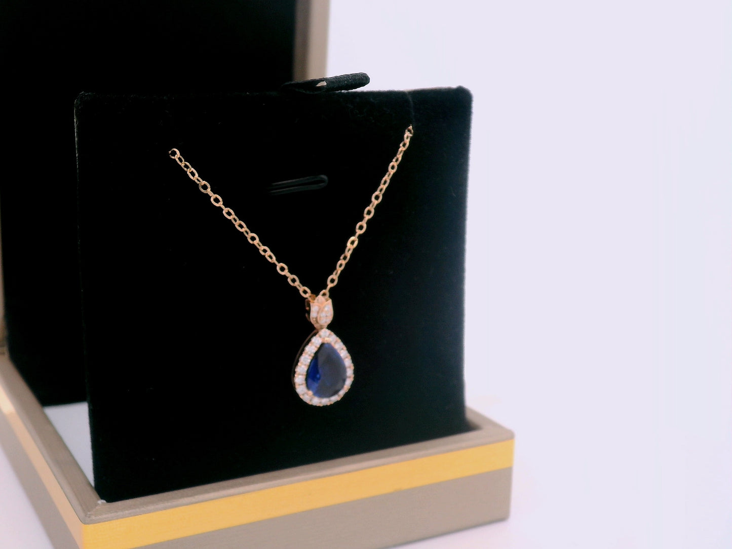 18K rose gold sapphire pendant with halo and diamond-accented bail