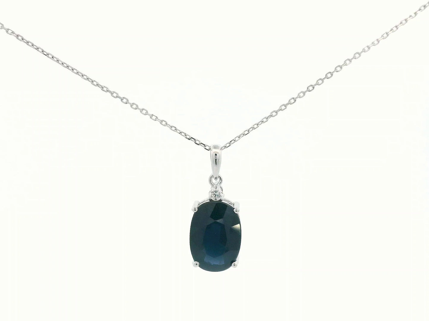 Oval-cut blue sapphire pendant with round diamond in white gold