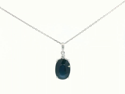 Oval-cut blue sapphire pendant with round diamond in white gold