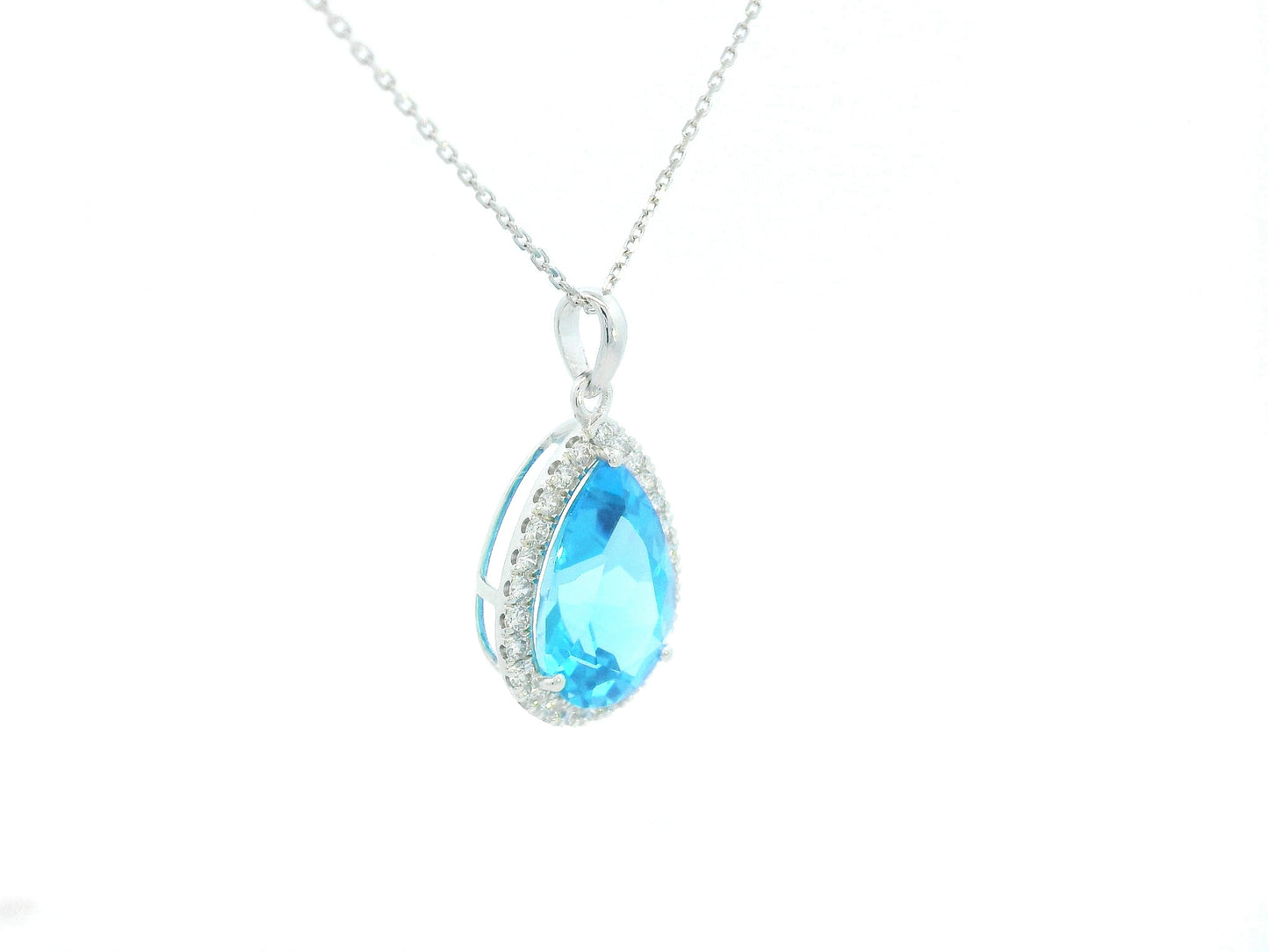 Blue teardrop pendant with chain on a white background