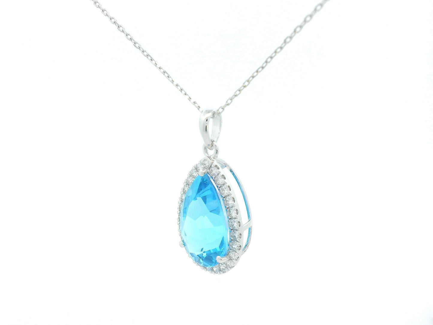 Teardrop-shaped blue gemstone pendant on a white background