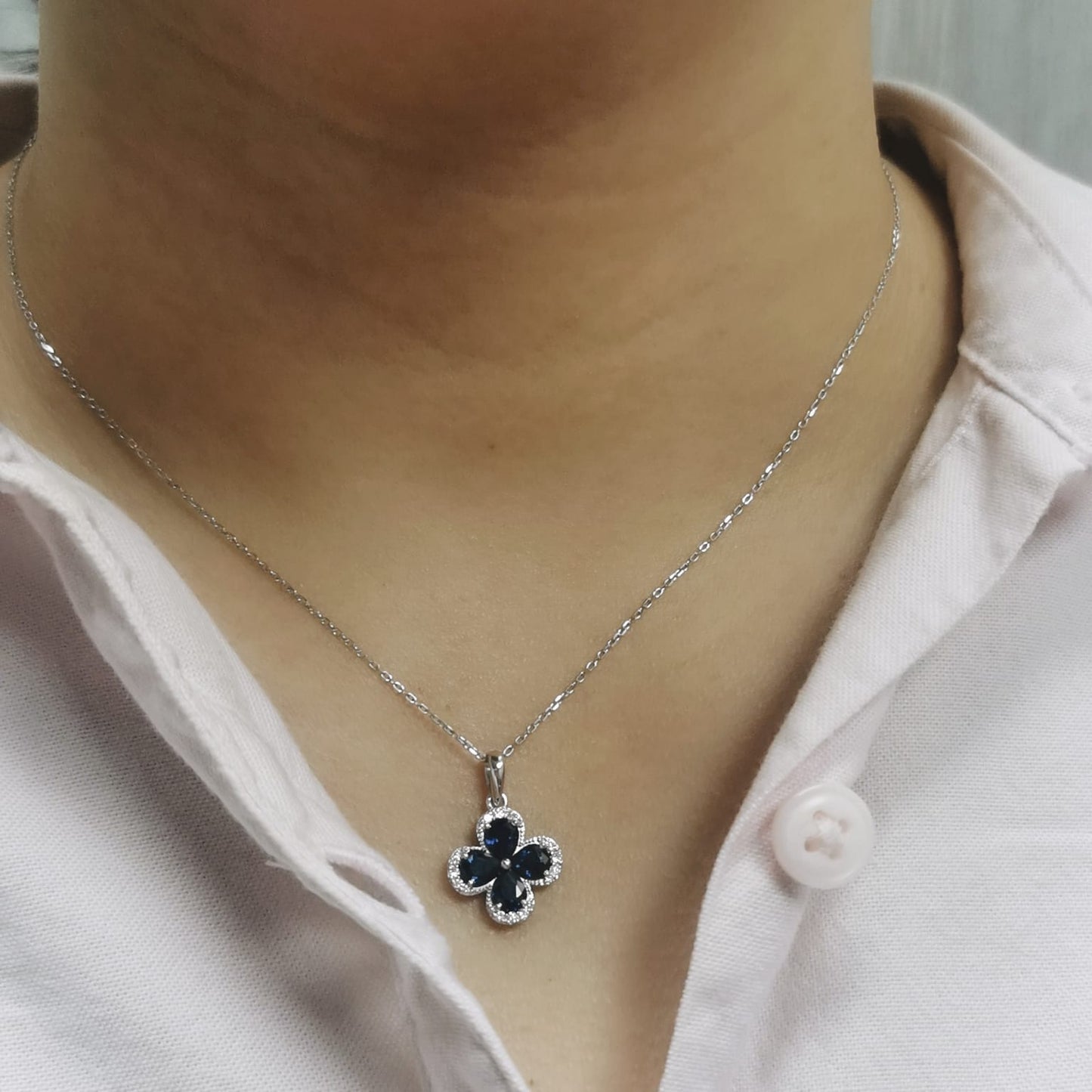 Blue sapphire and diamond flower pendant for women