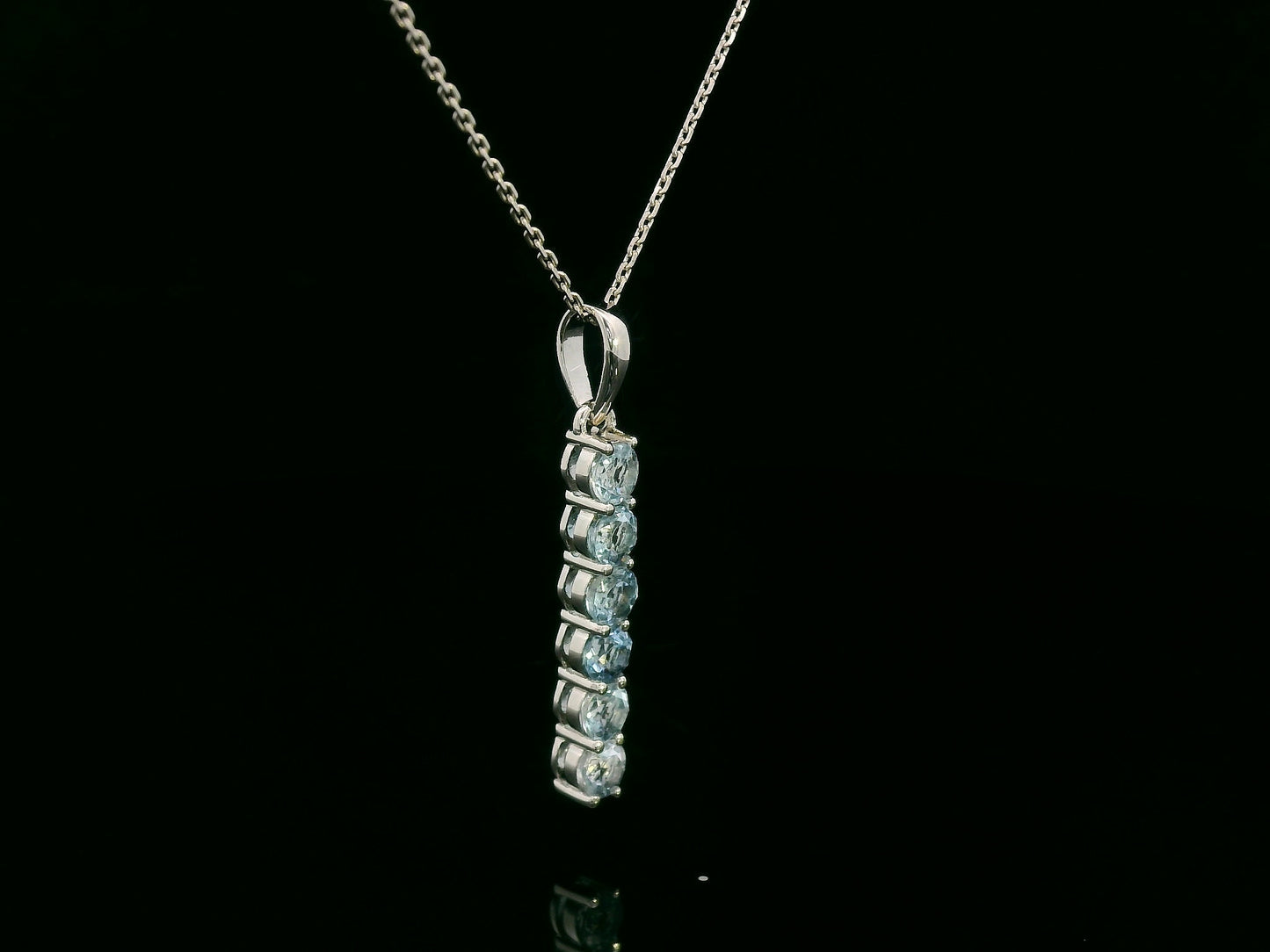 18k gold vertical bar pendant with six round-cut aquamarines totaling 0.72 carat
