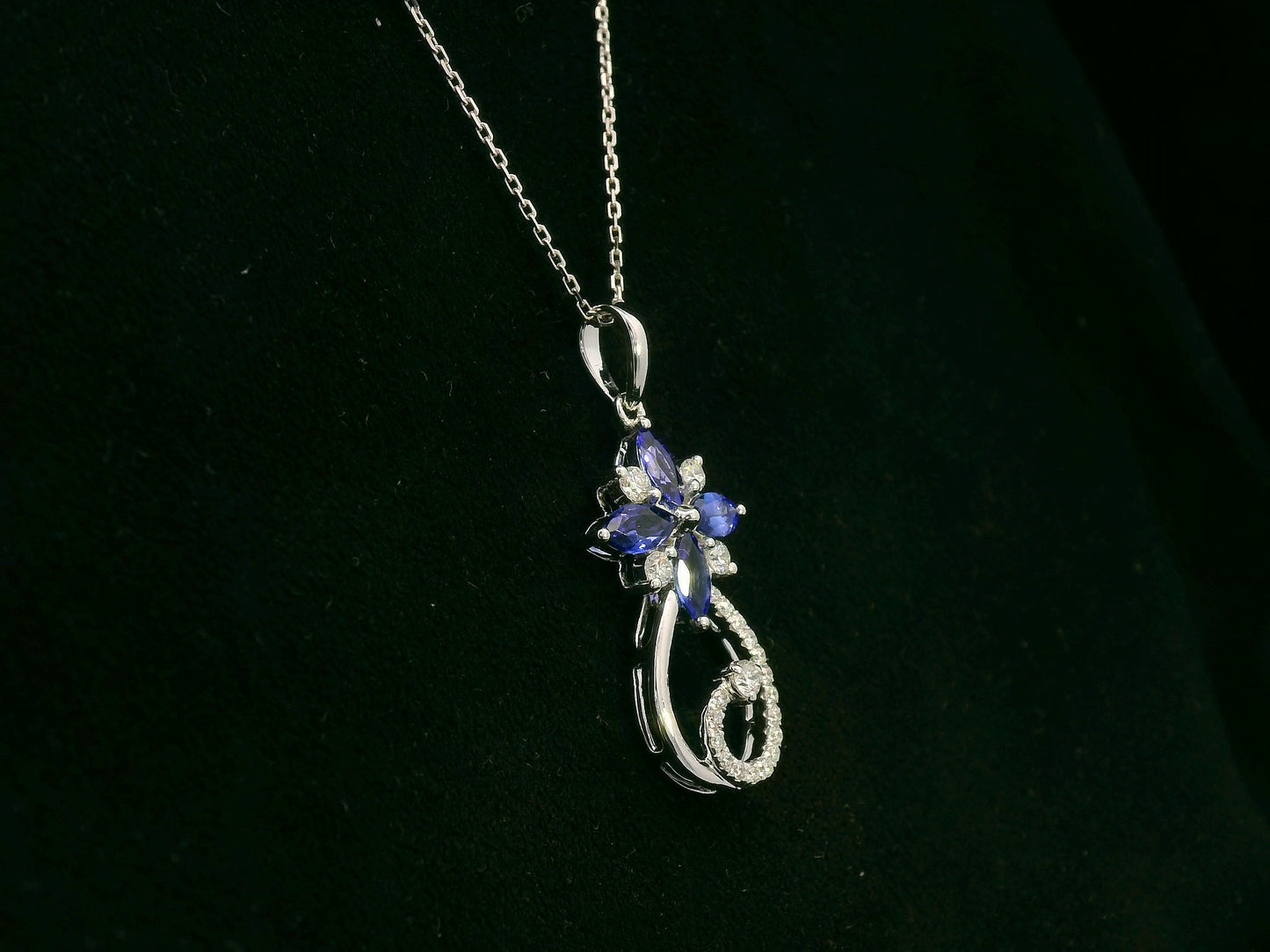 18K white gold Tanzanite and diamond floral paisley pendant featuring marquise-cut Tanzanites and pavé-set diamonds