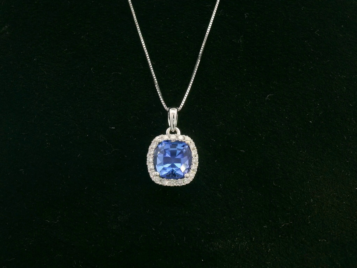 18K white gold Tanzanite and diamond halo pendant with cushion-cut 2.02 carat center stone